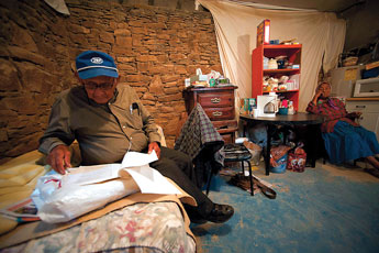 Herbert Largo's wife Alice watches as he sifts through paperwork he has kept during the construction of his home and the fight he has undertaken over the years to get it finished. © 2011 Gallup Independent / Adron Gardner 